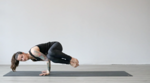 girl doing yoga on a grey mat